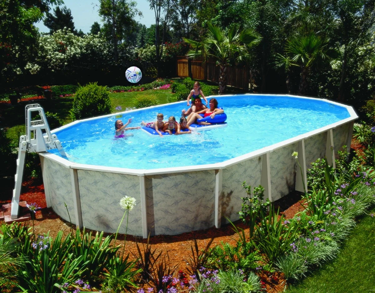Above-ground swimming pool with family enjoying leisure activities, surrounded by lush greenery and flowers, illustrating comfort and outdoor enjoyment.