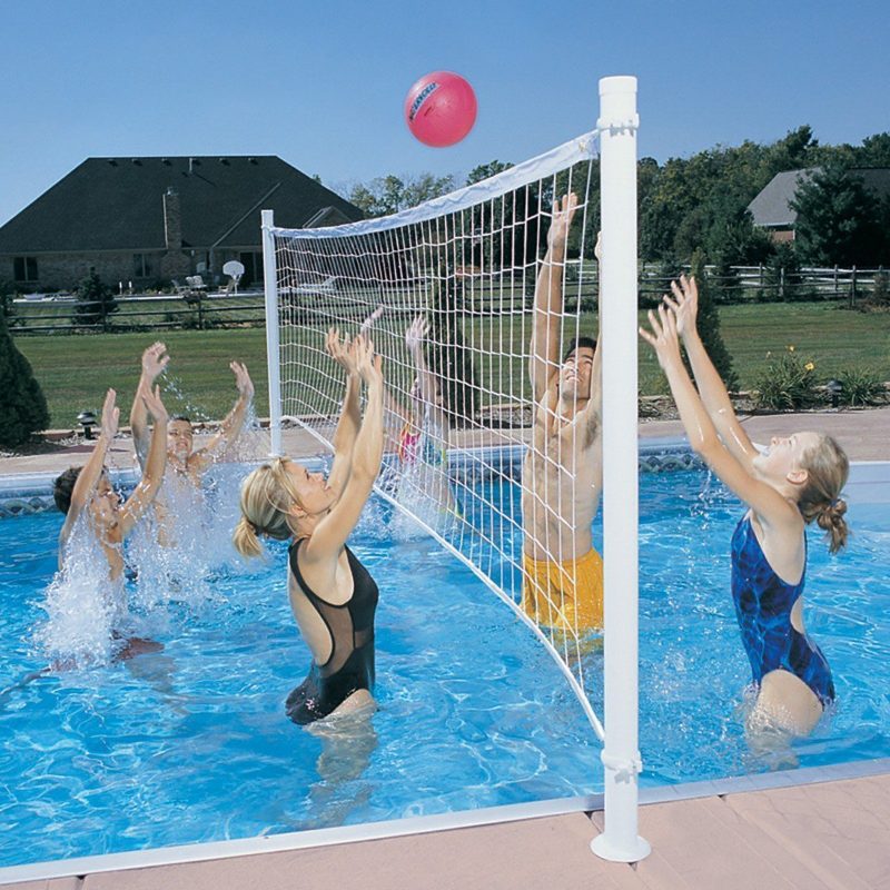 Group of people playing water volleyball in a pool, with a volleyball net and a pink ball, showcasing fun and leisure activities related to pool ownership.