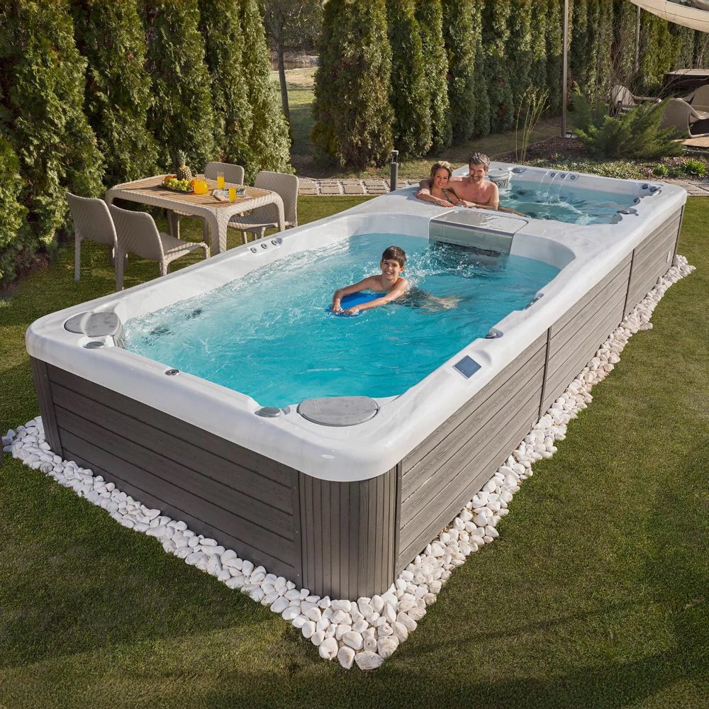 Family enjoying a Wellis Swimline spa with clear water, surrounded by greenery and outdoor seating, highlighting leisure and relaxation in spa maintenance context.