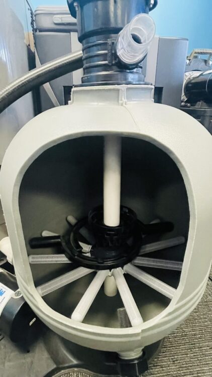 Pool filter system showcasing internal components, including filter cartridges and central hub, highlighting equipment for maintaining pools and spas.