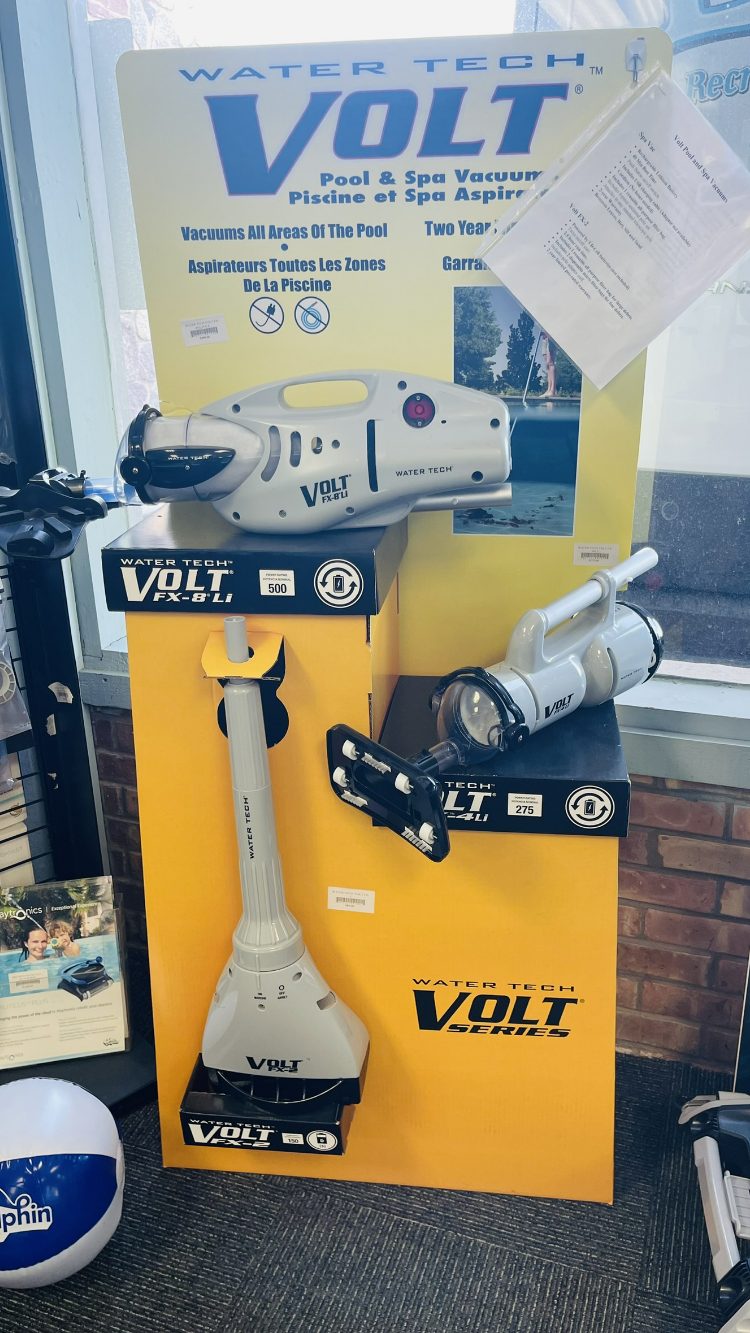 Water Tech Volt pool and spa vacuum cleaners displayed in Leisure Pools & Spas store, featuring models FX-8Li and FX-2, highlighting quality cleaning solutions for outdoor leisure products.