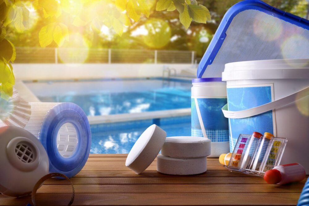 Pool cleaning and water testing supplies near a pool